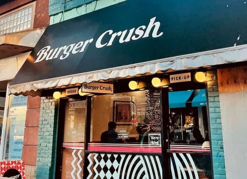 The Burger Crush storefront with its green awning and pick-up window