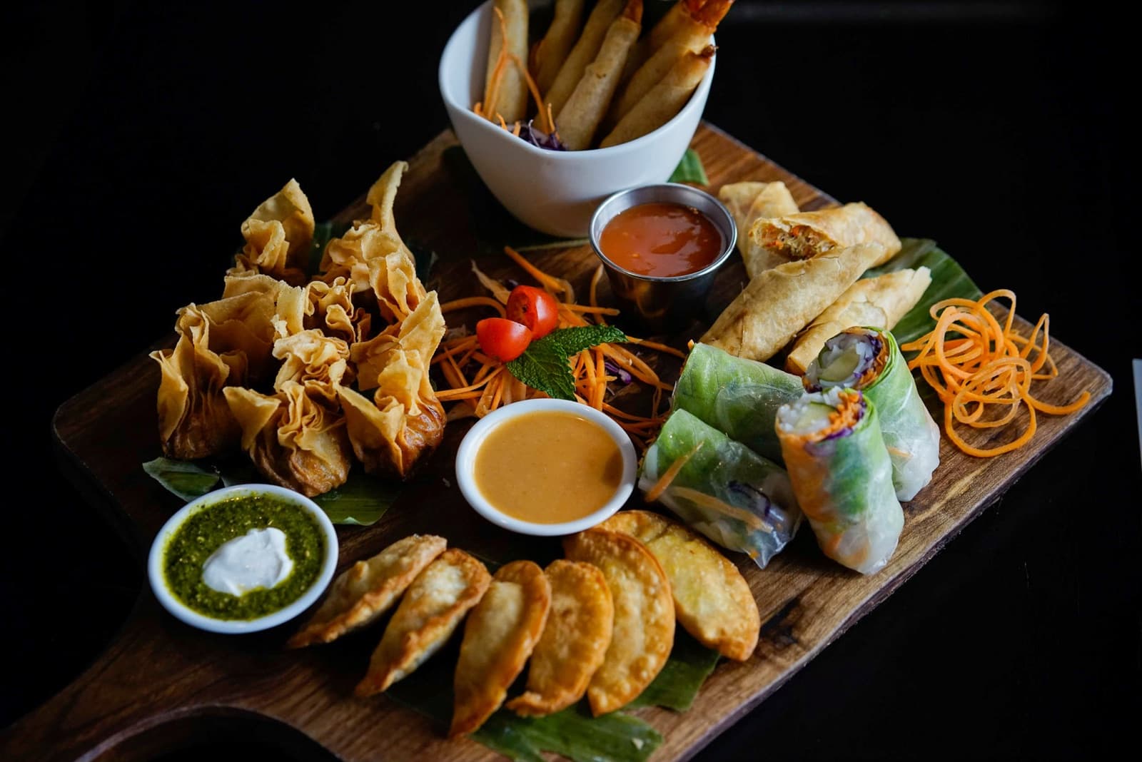 A board of Thaifoon's dumplings, spring rolls and dipping sauces